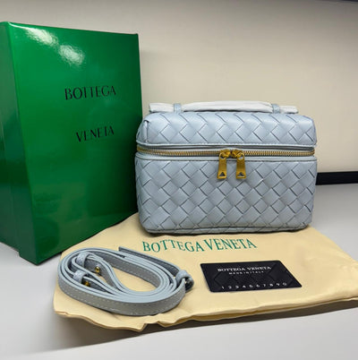 Bot tega Ven eta handbag with green packaging and beige pouch on a light blue background