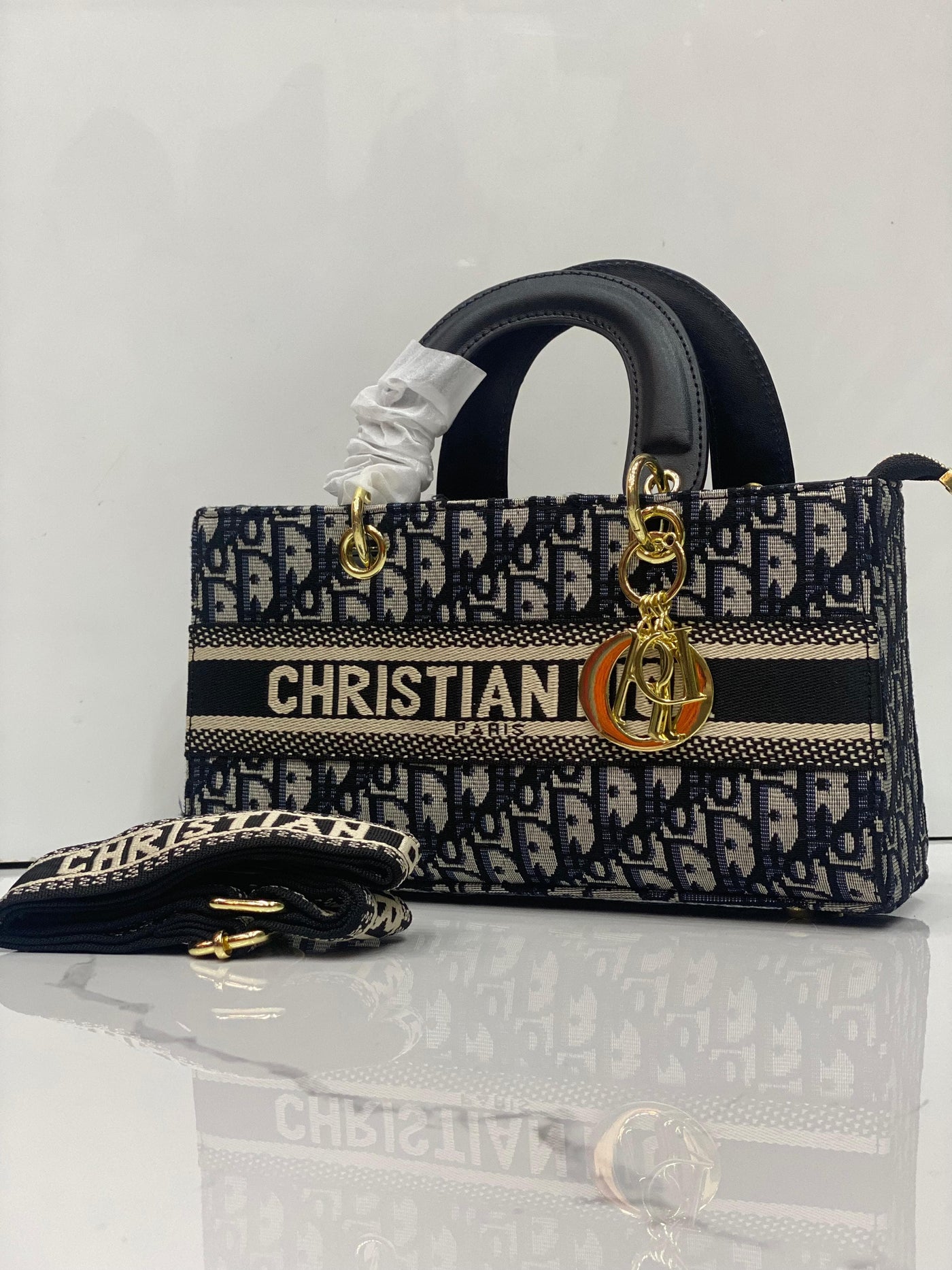Chris tian Di or handbag with monogram pattern on a white background