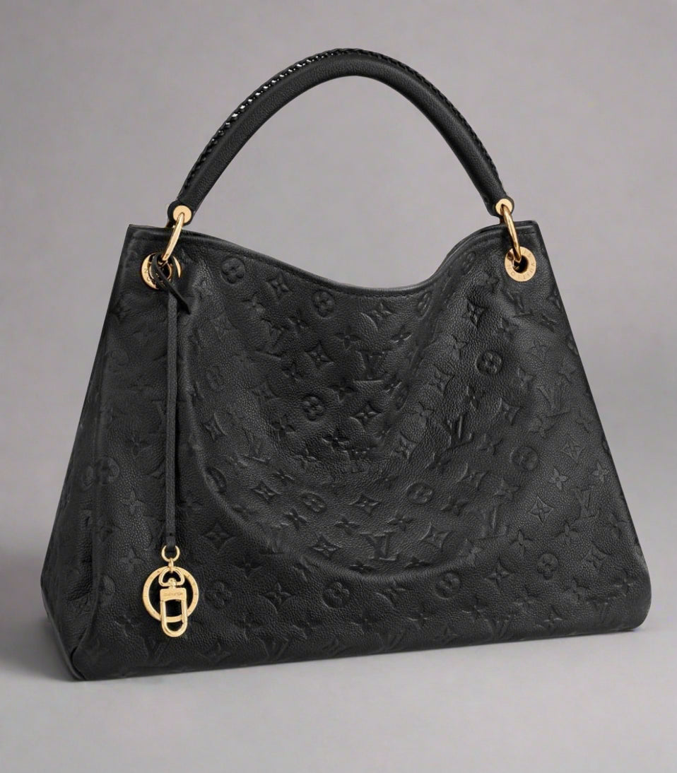 Black handbag with gold accents on a white background