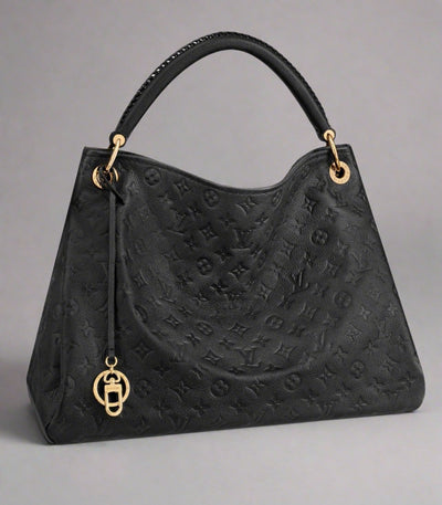 Black handbag with gold accents on a white background