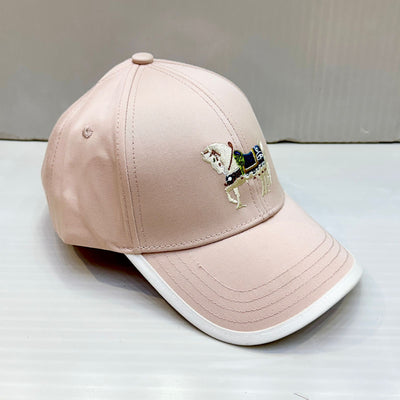 pink cap with embroidered design on a white surface