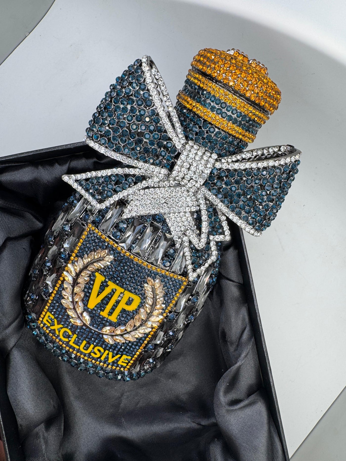 rhinestone-embellished clutch bag shaped like a bottle, with a bow and the text for Women